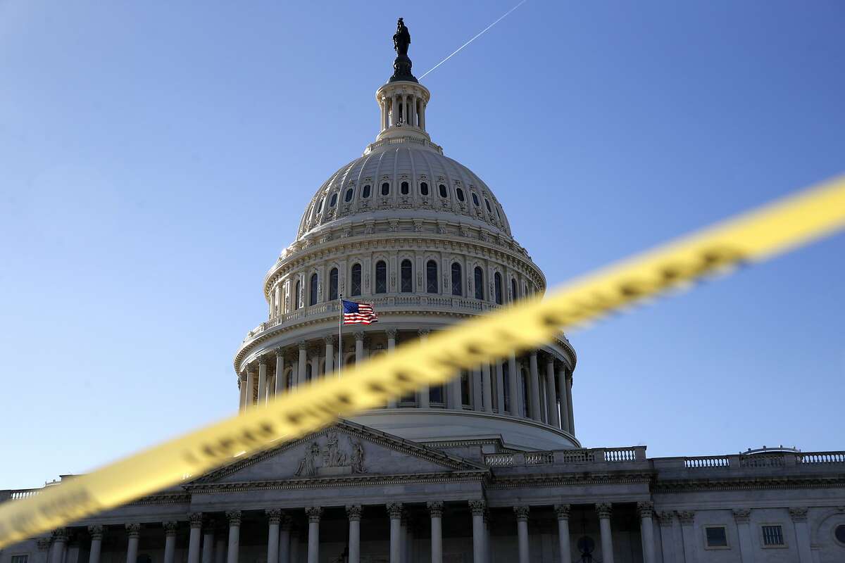 Police tape marks a secured area of the Capitol, Friday, Jan. 19, 2018, in Washington, as a bitterly-divided Congress hurtles toward a government shutdown this weekend. (AP Photo/Jacquelyn Martin)