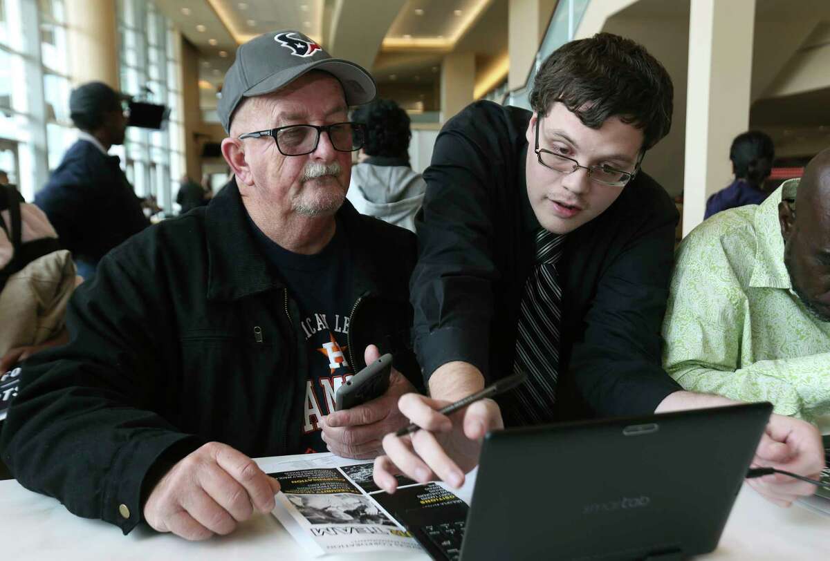 The HLSR is looking to hire 1,000 part-time positions during a massive "Texas-Sized" job fair this weekend. (File caption: Job applicant Kyle Glaze, right, helps another applicant Donald Bozeman to fill out an electronic application at Houston Livestock Show and Rodeo's job fair at NRG Stadium on Saturday, Jan. 20, 2018, in Houston. ( Yi-Chin Lee / Houston Chronicle )