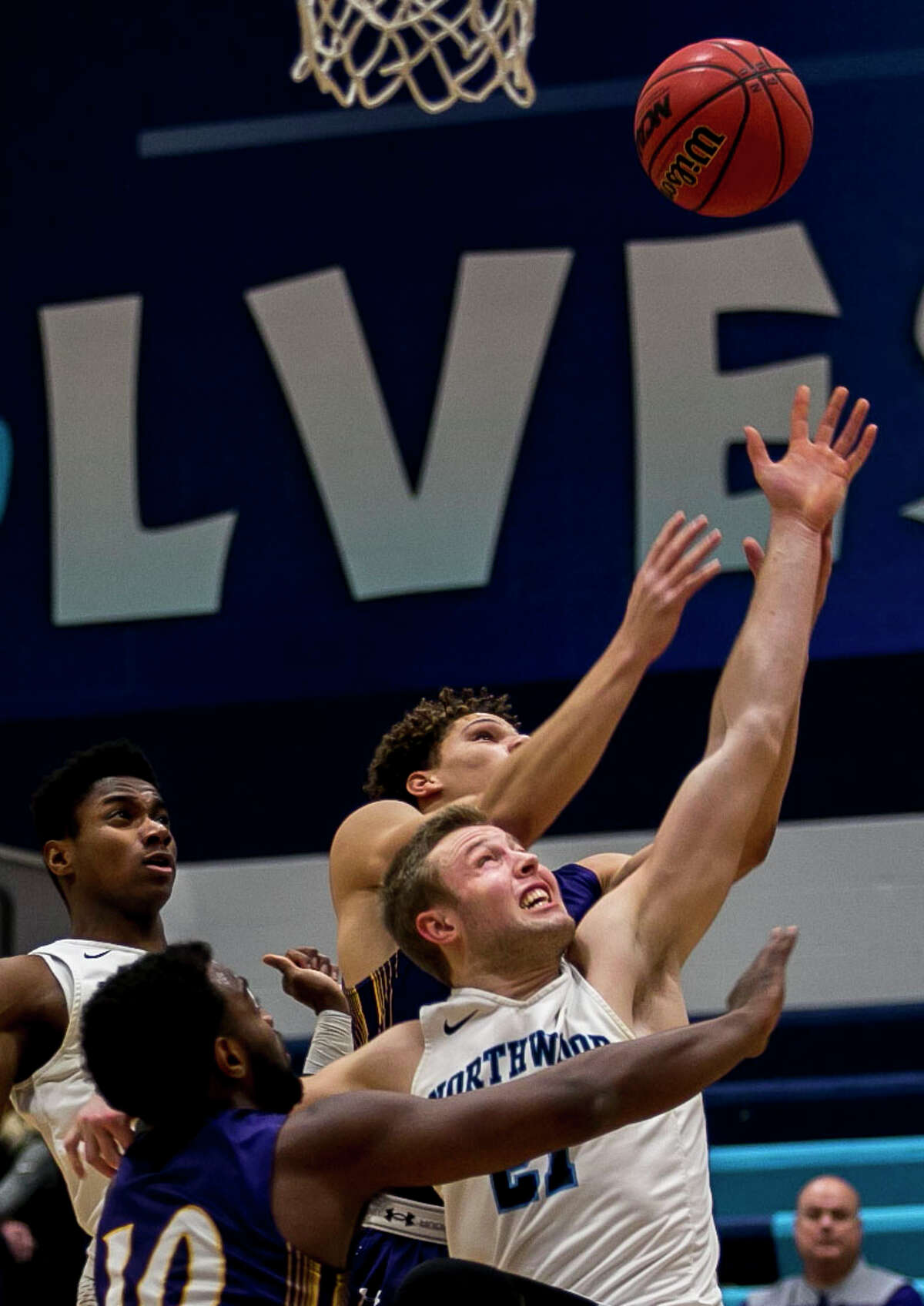 Northwood's Zach Allred reaches for the rebound with Ashland's defense during a game against Ashland on Saturday, Jan. 20, 2018 at Northwood University. (Josie Norris/for the Daily News)
