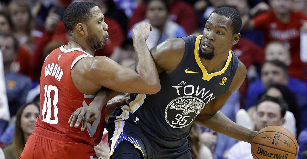 Golden State Warriors forward Kevin Durant (35) looks to pass the ball under pressure from Houston Rockets guard Eric Gordon (10) during the second half of an NBA basketball game Saturday, Jan. 20, 2018, in Houston. (AP Photo/Michael Wyke)
