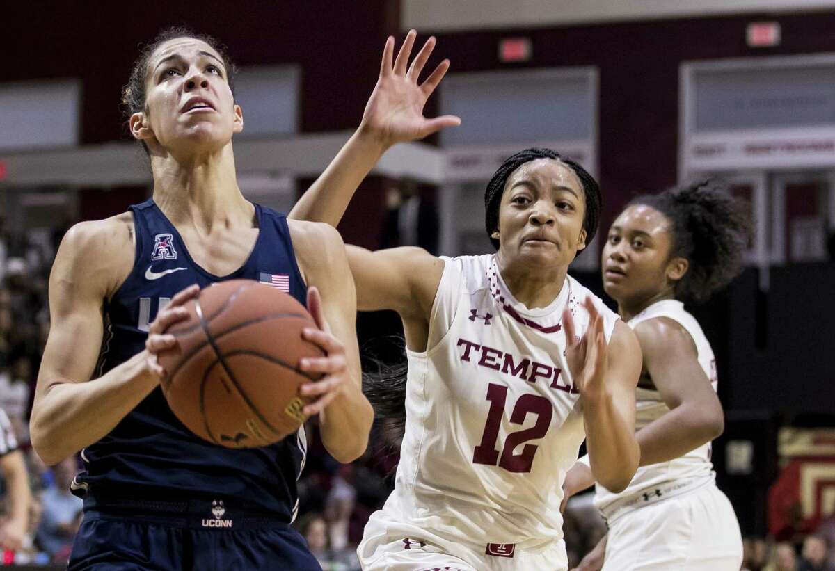 UConn’s Kia Nurse, left, looks to go for the shot as Temple’s Emani Mayo gives chase Sunday in Philadelphia.