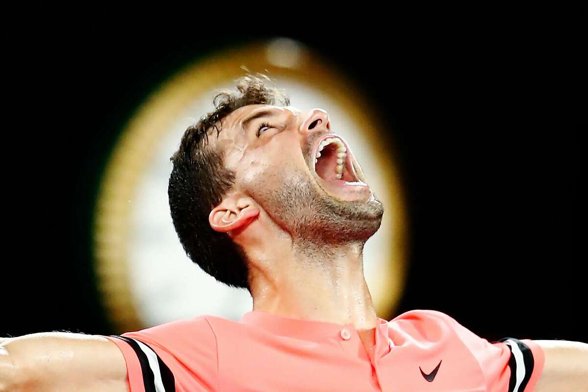MELBOURNE, AUSTRALIA - JANUARY 21: Grigor Dimitrov of Bulgaria celebrates winning in his fourth round match against Nick Kyrgios of Australia on day seven of the 2018 Australian Open at Melbourne Park on January 21, 2018 in Melbourne, Australia. (Photo by Michael Dodge/Getty Images)