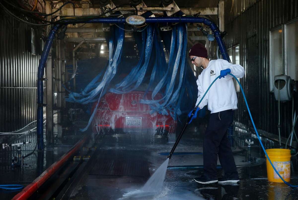 Cole Gomez cleans the area after washing a car at the 5 Star Car Wash and Detail Center, Saturday, Jan. 20, 2018, in Fairfield, Calif.