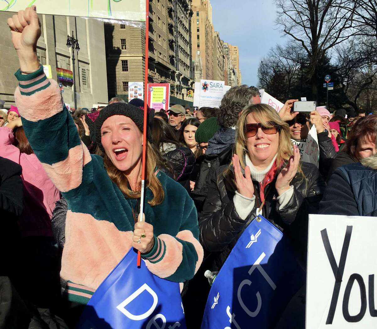 Darcy Hicks, left, of Westport, and Laura Totten of Stamford react to a speech by Whoopi Goldberg in the New York Women's March 2018. Hicks founded DefenDemocracy of Connecticut, a political action group, after the 2017 Women’s March.