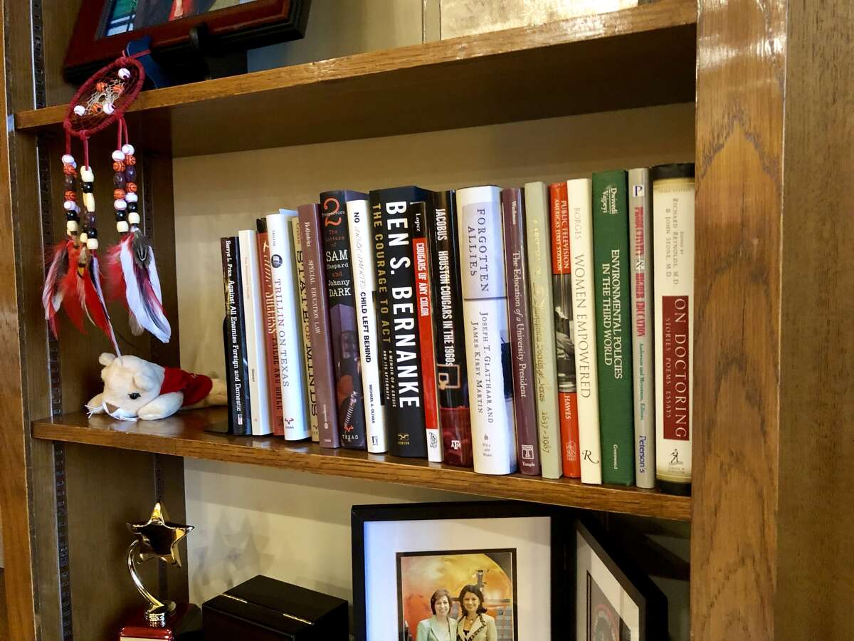 Bookshelves line UH President Renu Khator's office. Here's a sampling of what's on one of them.