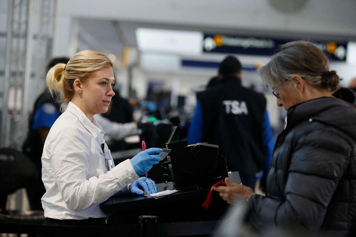 A Travel Document Checker checks licenses at a checkpoint at the Oakland International Airport on Tuesday, January 23, 2018 in Oakland, Calif.