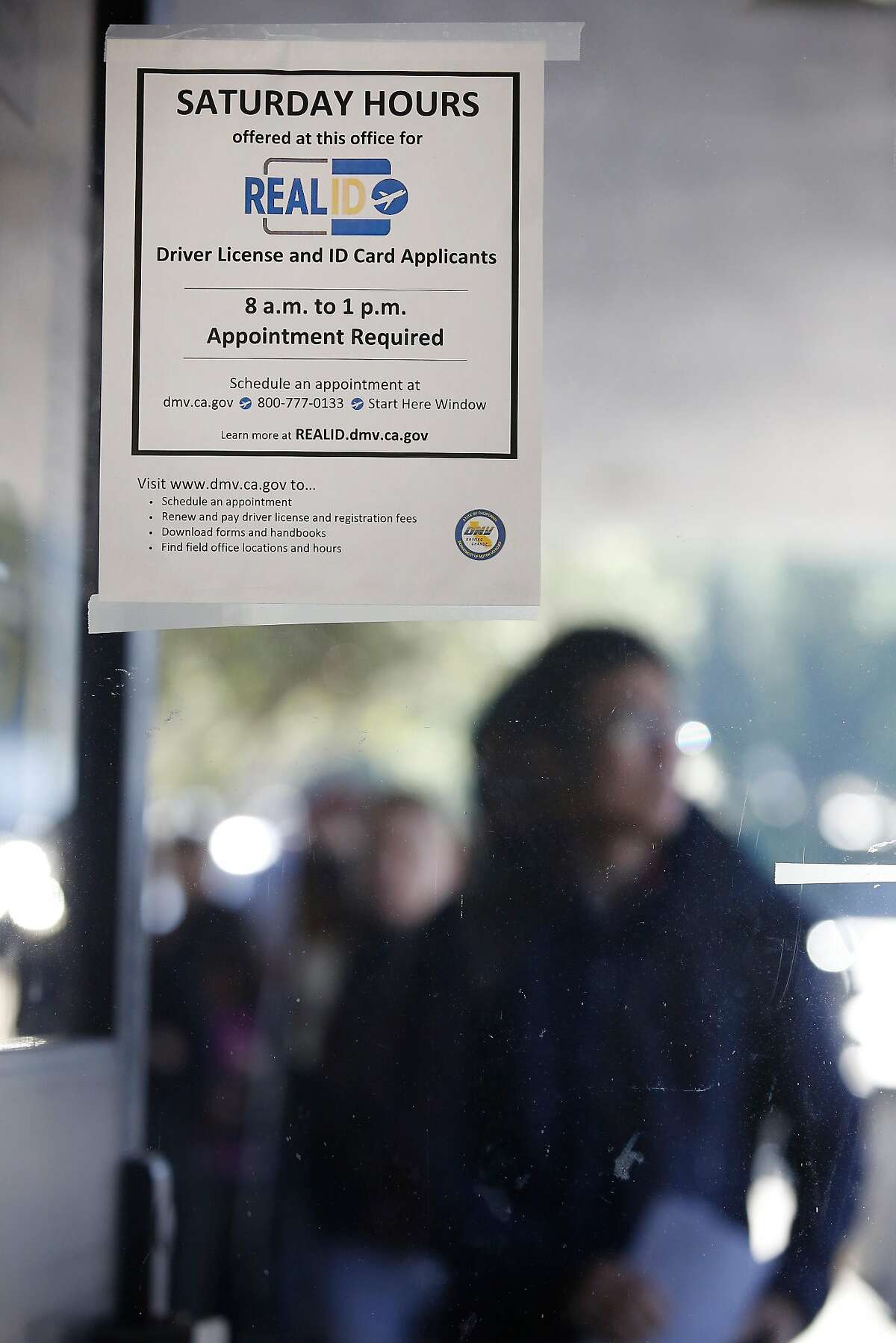 A sign for Saturday hours for Real ID applicants is seen at the Department of Motor Vehciles on Tuesday, January 23, 2018 in Daly City, Calif.