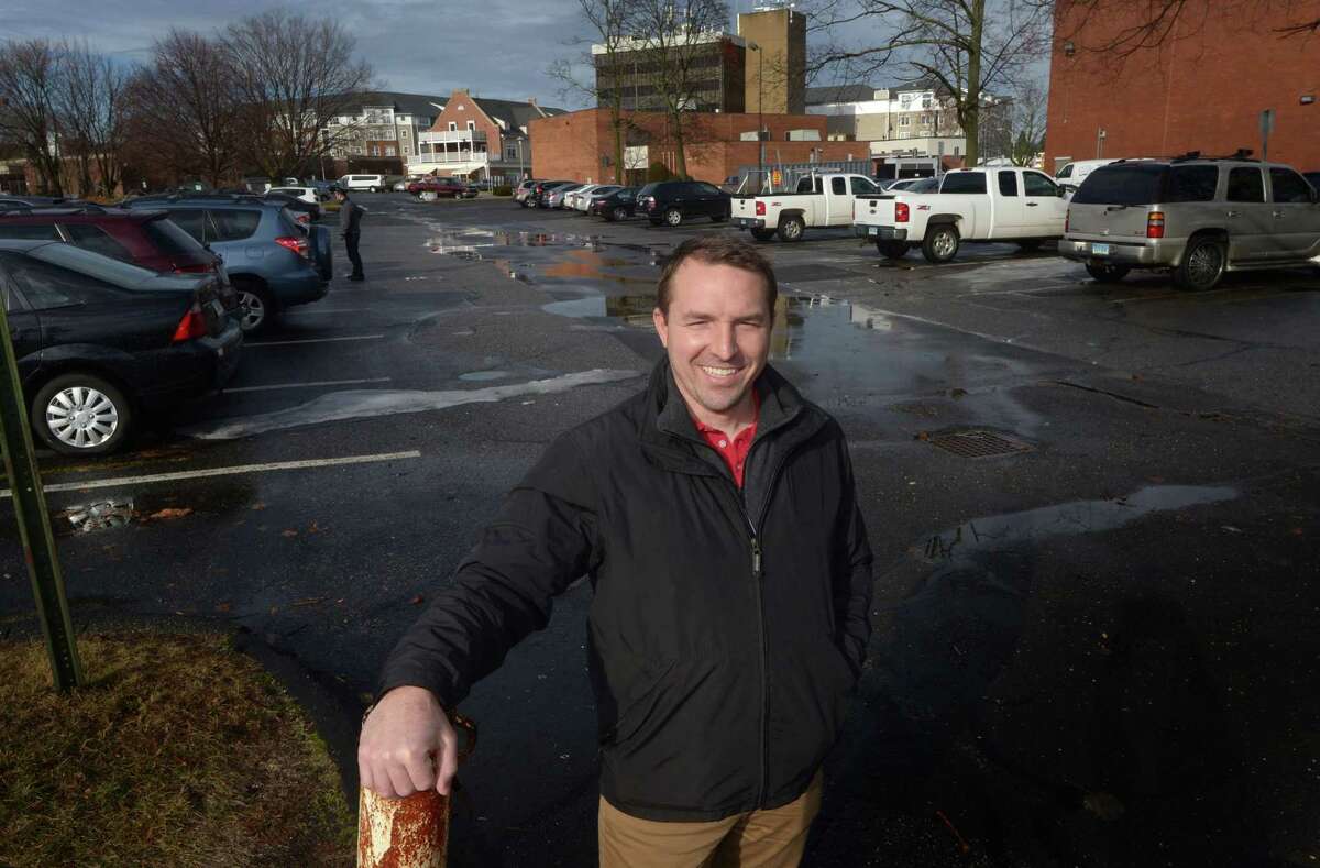 Jason Milligan, owner of Milligan Real Estate, in the newly opened parking lot he owns adjacent to the Norwalk Public Library Main Branch Tuesday in Norwalk. City officials, after meeting with the Norwalk Parking Authority on Tuesday afternoon, gained clarity on when the private parking lot adjacent to the Main Library on Belden Avenue will be reopened to the public and when physical alterations to the lot might begin.