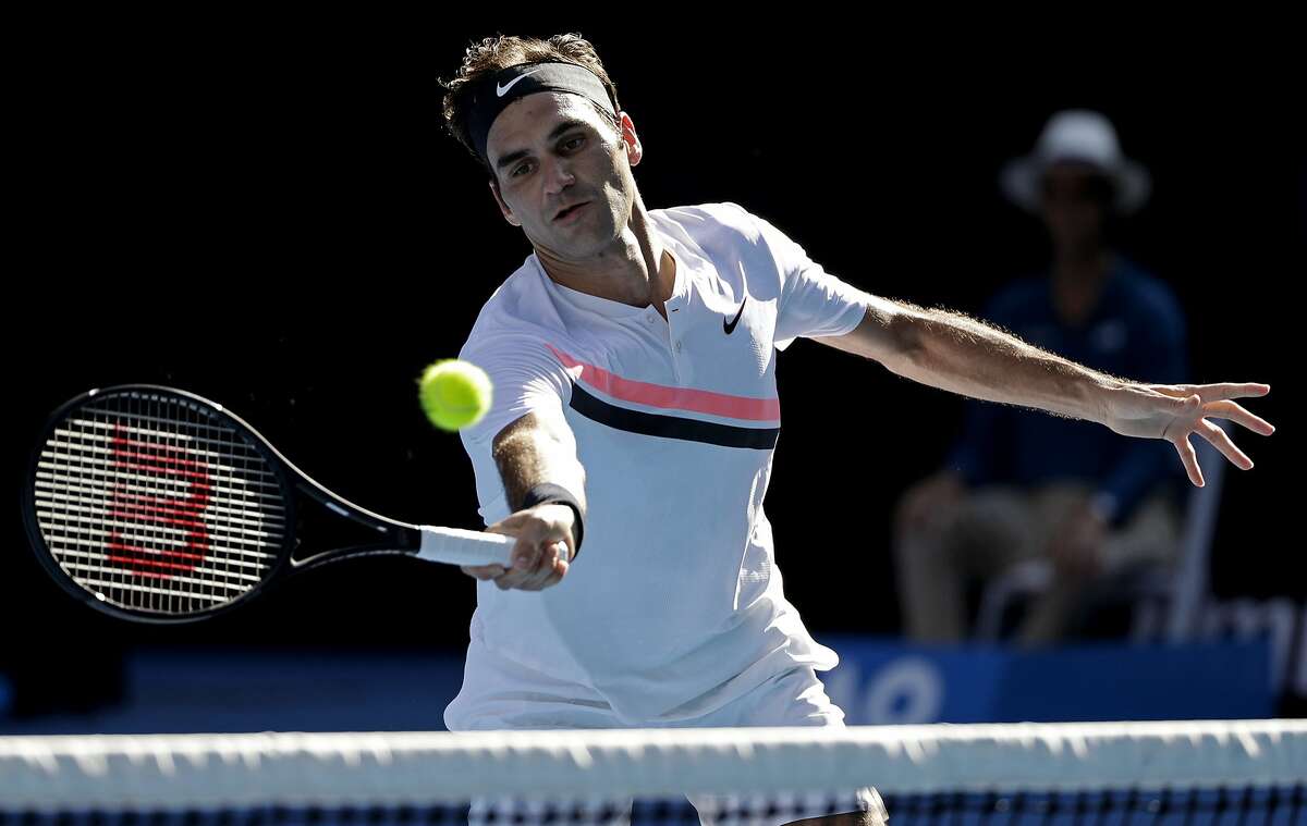 Switzerland's Roger Federer makes a forehand return to Hungary's Marton Fucsovics during their fourth round match at the Australian Open tennis championships in Melbourne, Australia, Monday, Jan. 22, 2018. (AP Photo/Dita Alangkara)