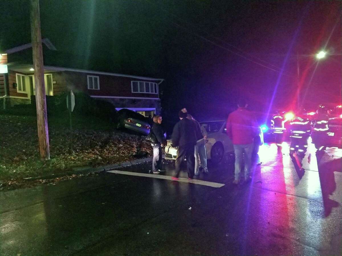 A three-vehicle crash on Jan. 23, 2018, left one car in someone's front lawn in Bridgeport, Conn.