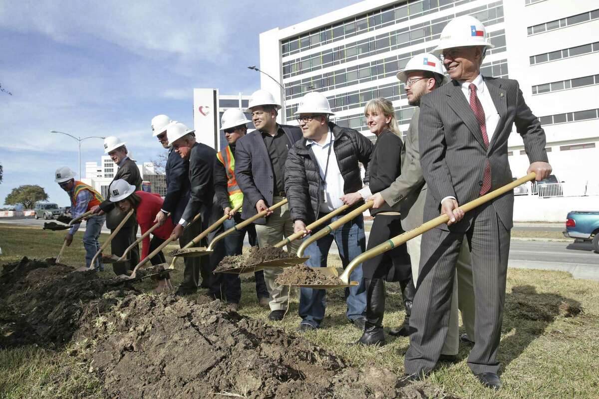 Razi Hosseini (right) leads the group turning the first shovels as the Floyd Curl Green Street project, to include a bicycle two-way track, is started with a groundbreaking on January 23, 2018.