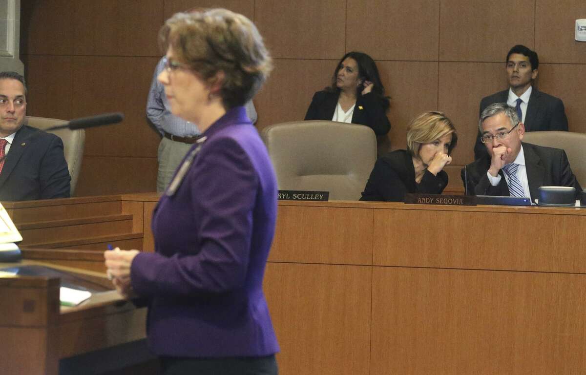 San Antonio City Manager Cheryl Sculley (second from right) and City Attorney Andy Segovia (right) share conversation Thursday September 21, 2017 during a city council session as District 6 councilman Greg Brockhouse (left) watches. Speaking (foreground, center) is Director of Health Colleen M. Bridger about teen pregnancy prevention.