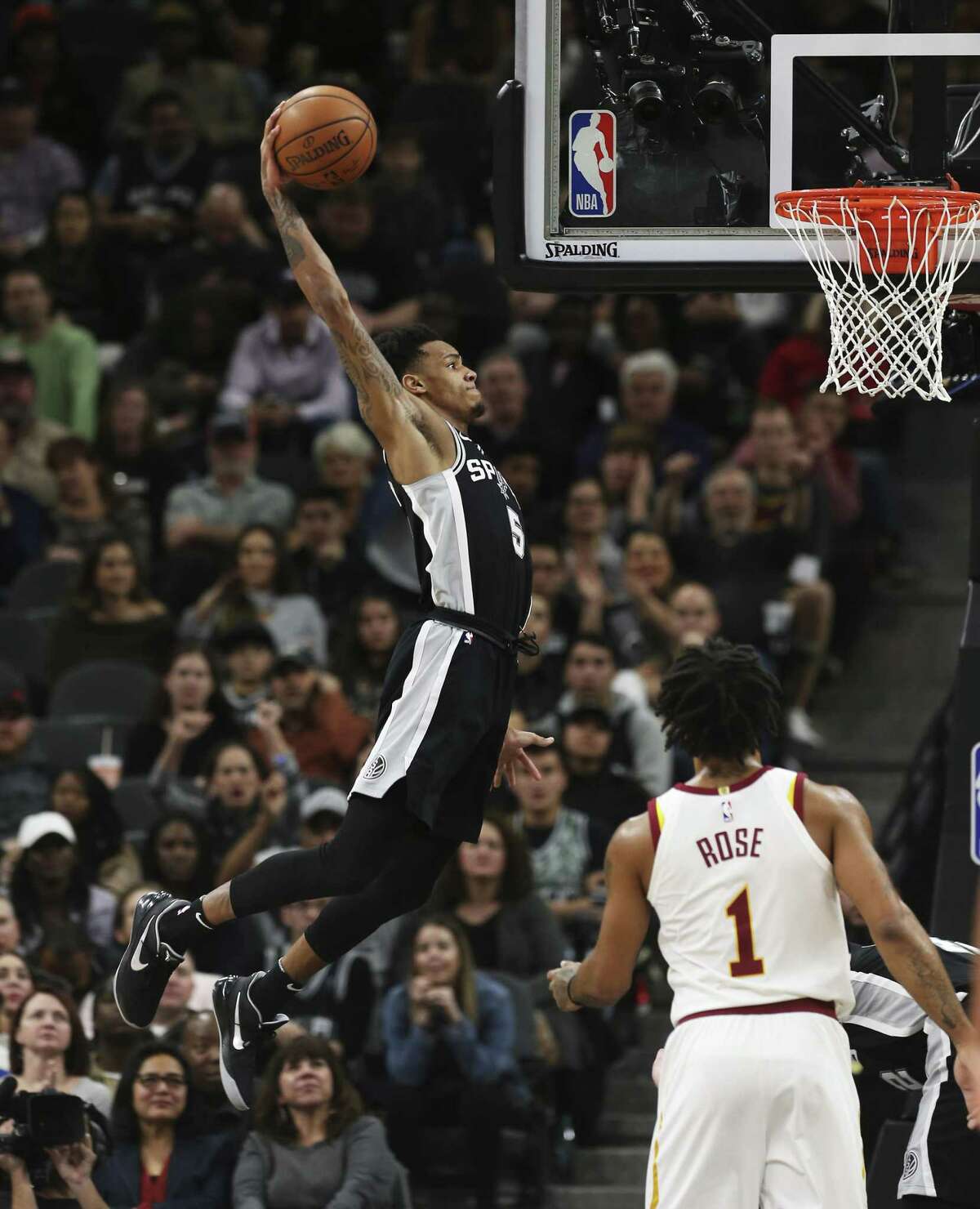 Spurs' Dejounte Murray (05) rears back for dunk against Cleveland Cavaliers' Derrick Rose (01) at the AT&T Center on Tuesday, Jan. 23, 2018. Spurs defeated the Cavs, 114-102. (Kin Man Hui/San Antonio Express-News)
