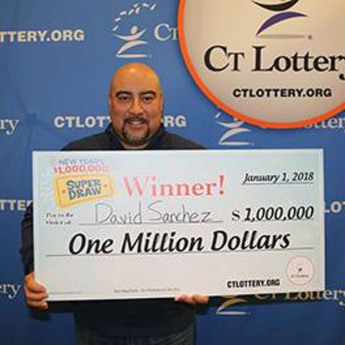 David Sanchez, of Bridgeport, holds his $1 million winning prize in CT Super Draw lottery ticket.