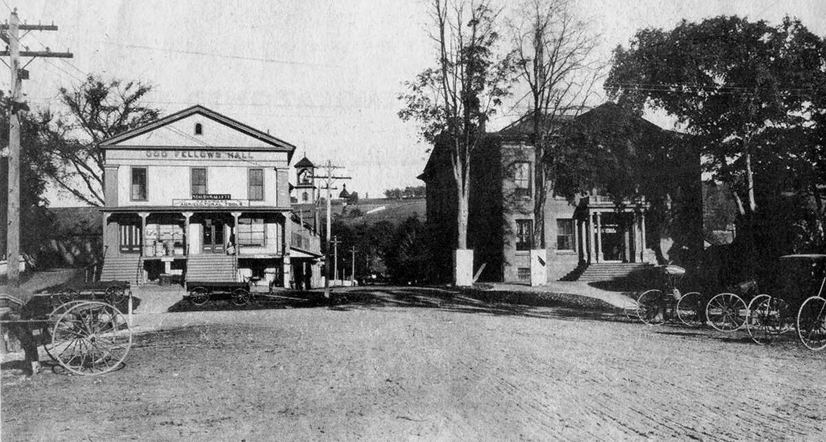 This late 19th-century photographic view from the west side of Main Street in New Milford's historic village shows parking for horses and carriages along the plaza between Church and Bank streets was arranged much the same as today for motorized vehicles. Note the building to the left now called home by the Village Center for the Arts was then called the Odd Fellows Hall. It had originally been built for use as a church but soon became the home for more than a century for the Village Hardware business. The Roger Sherman Town Hall was shaded by towering elm trees such as those that lined the Village Green for many years. Until its entrance was altered several decades ago, the town hall as it appears here matches that of its sister town hall in Gt. Barrington, Mass. If you have a photo you'd like to share, contact Deborah Rose at drose@newstimes.com or 860-355-7324.