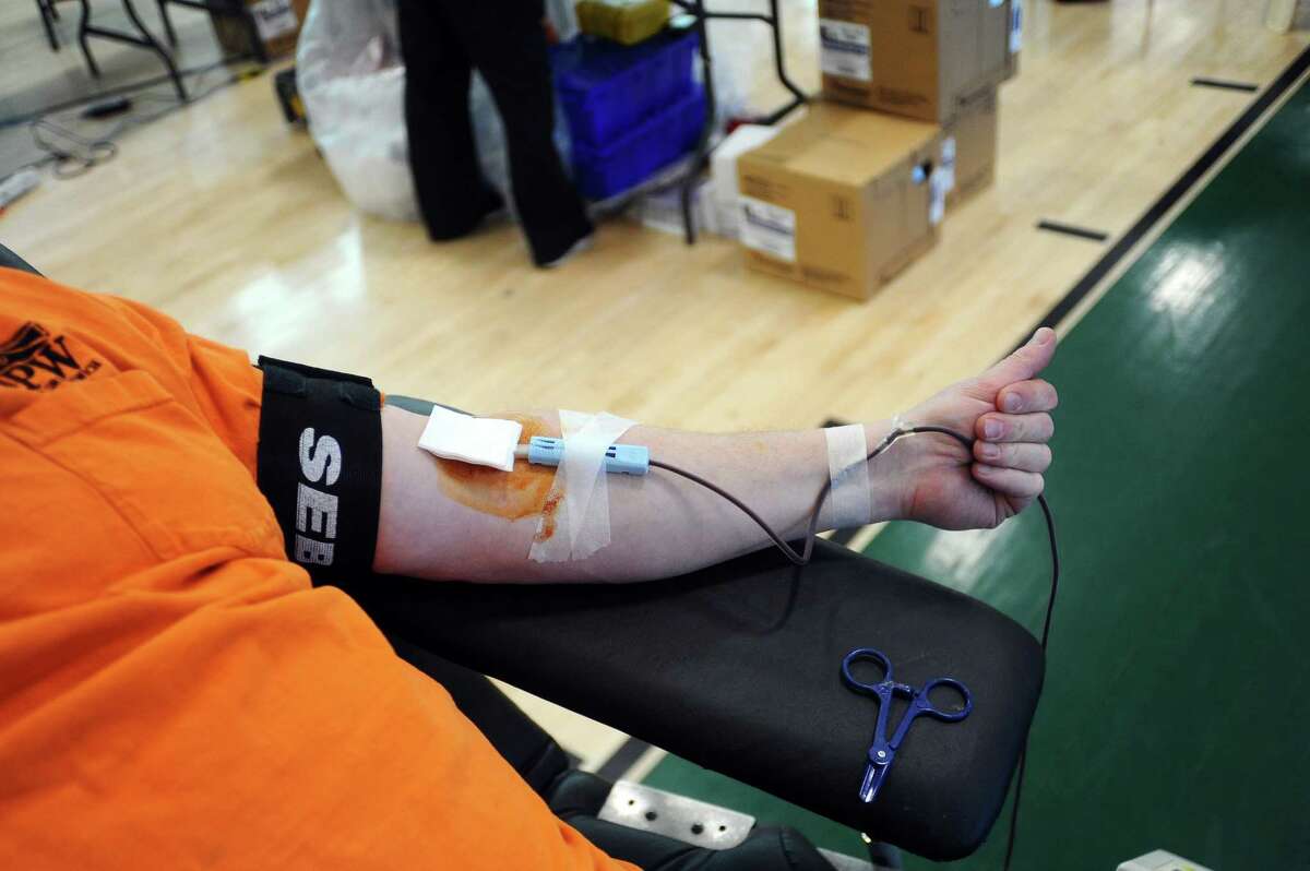 Donors give blood during an American Red Cross blooddrive inside the Rippowam Middle School gymnasium in Stamford, Conn. on Wednesday, Jan. 24, 2018. The Red Cross said there is an urgent need for blood because the seasonal flu has contributed to a spike in canceled donations.