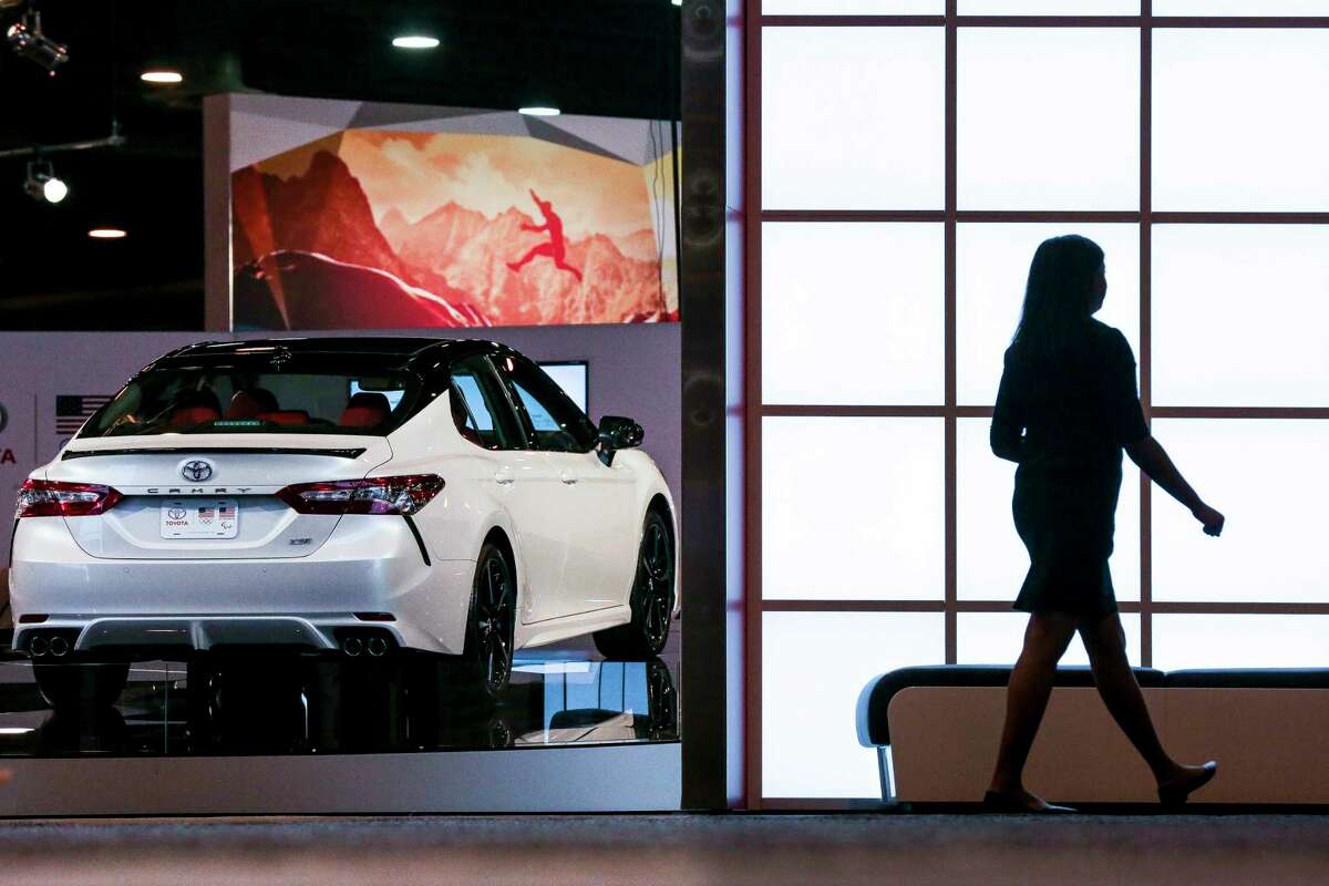 A woman walks past a Toyota Camry on display during the first day of the Houston Auto Show at NRG Center Wednesday, Jan. 24, 2018 in Houston. ( Michael Ciaglo / Houston Chronicle)