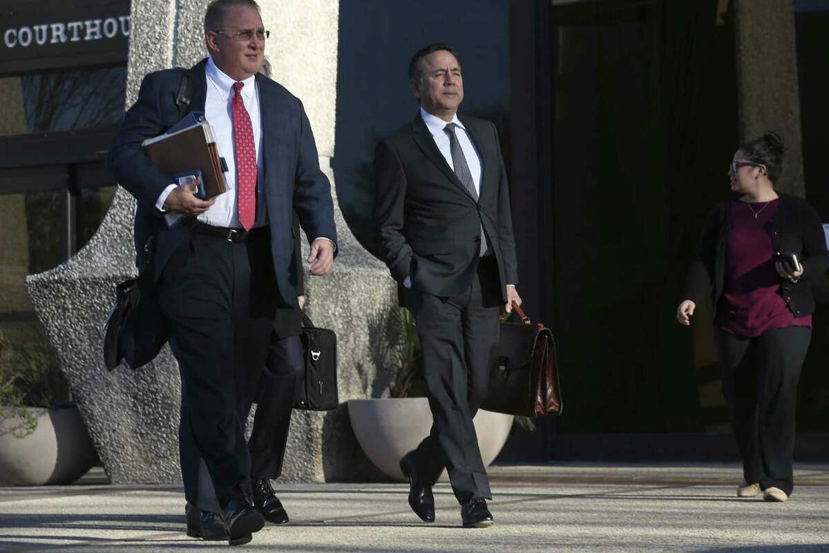 State Sen. Carlos Uresti leaves the John H. Wood Jr. Federal Courthouse, following the third day of his criminal fraud trial Wednesday. On his right is one of his lawyers, Tab Turner.