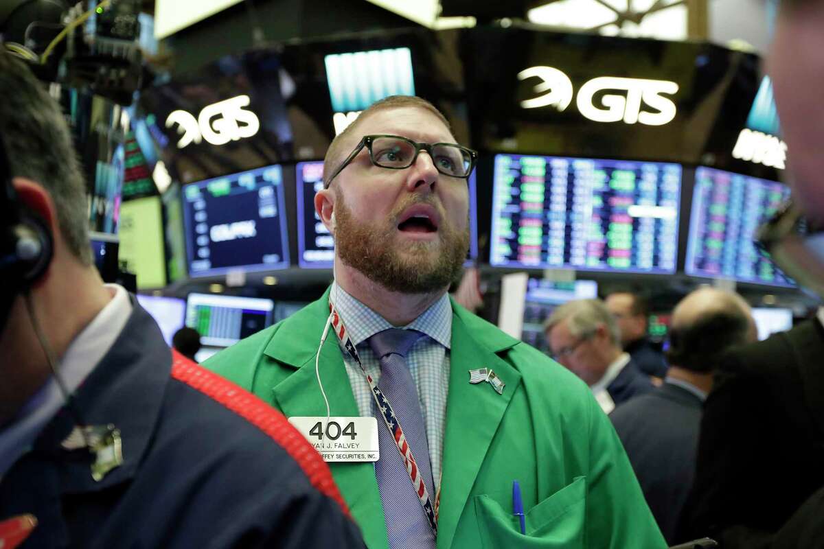 Trader Ryan Falvey works on the floor of the New York Stock Exchange, Wednesday, Jan. 24, 2018. Health care and consumer-focused companies are rising in early trading as stocks look to extend their winning streak to a fourth day. (AP Photo/Richard Drew)