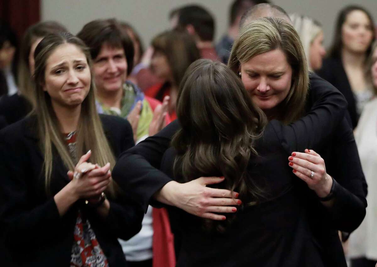 Victims react and hug Assistant Attorney General Angela Povilaitis after Larry Nassar was sentenced Wednesday. Nassar, employed by USA Gymnastics from the mid-1990s until 2015, pleaded guilty to seven counts of sexually assaulting athletes during his tenure.