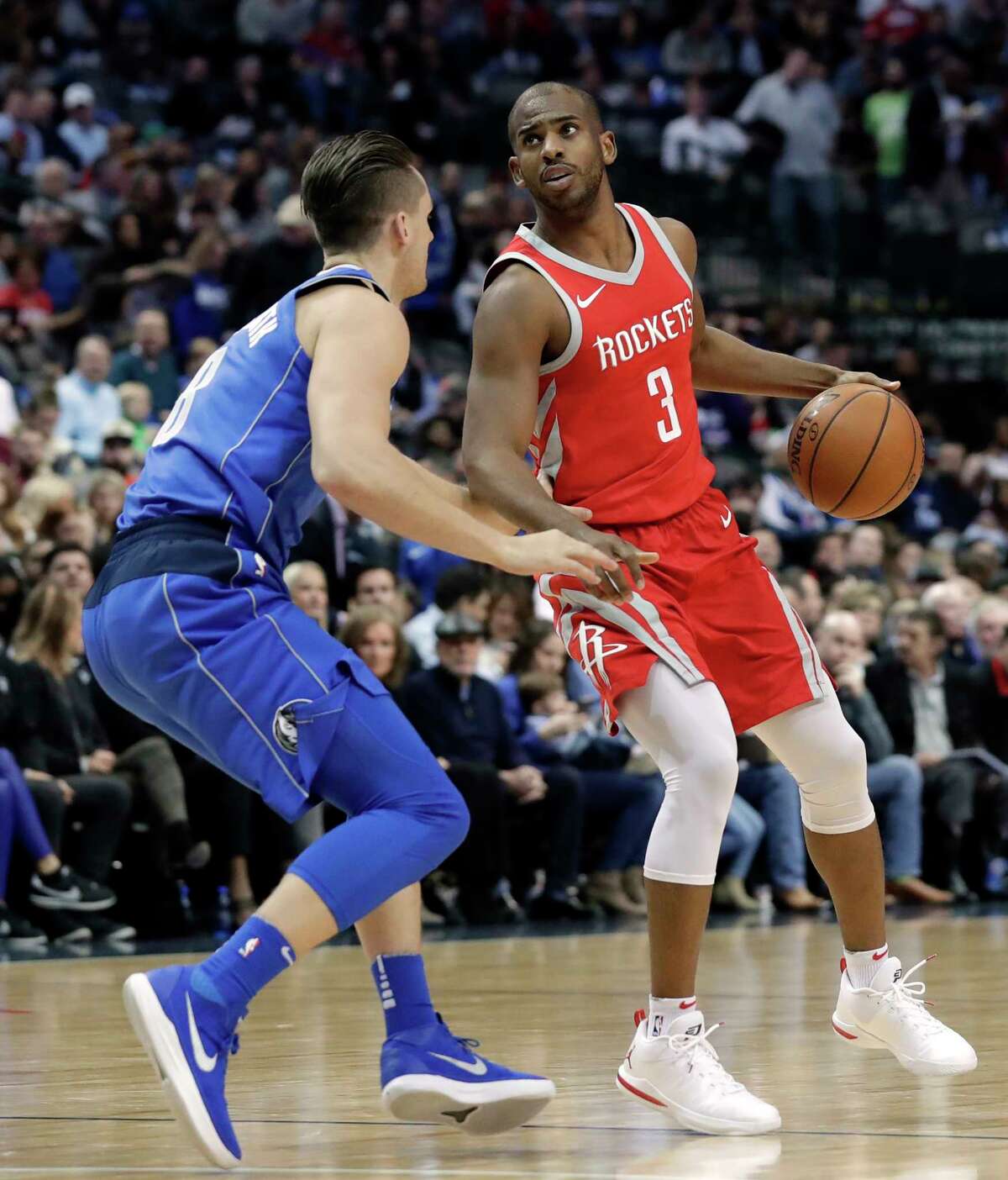 Dallas Mavericks guard Kyle Collinsworth (8) defends as Houston Rockets guard Chris Paul (3) handles the ball in the first half of an NBA basketball game Wednesday, Jan. 24, 2018, in Dallas. (AP Photo/Tony Gutierrez)