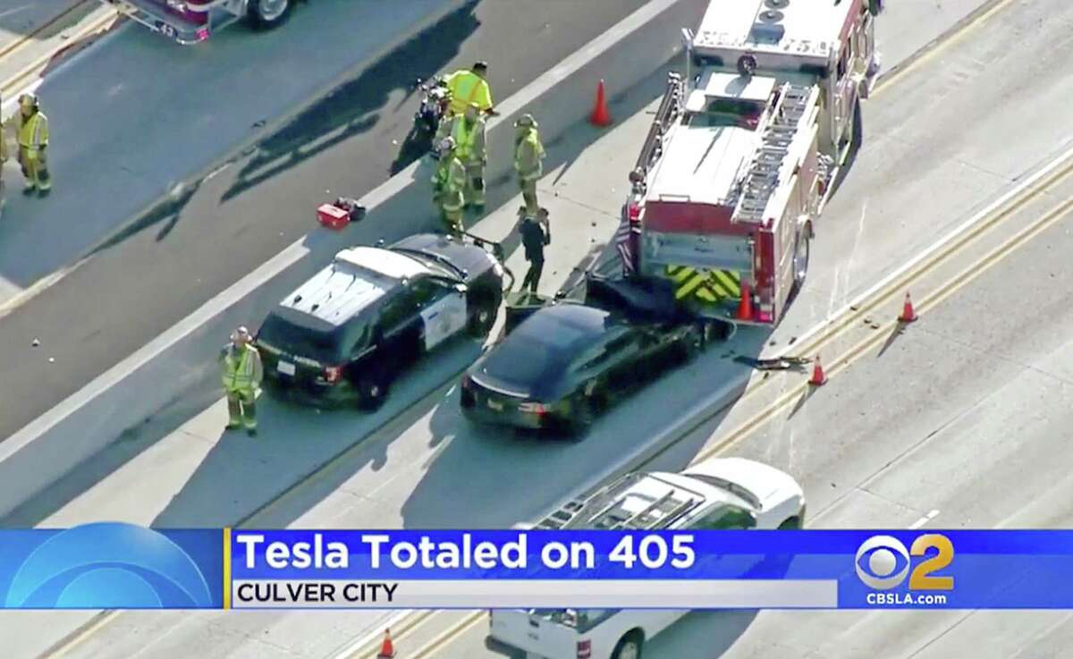 This Monday, Jan. 22, 2018 still frame from video provided by KCBS-TV shows a Tesla Model S electric car that has crashed into a fire engine on Interstate 405 in Culver City, Calif. Two federal agencies have dispatched teams to investigate the crash of the car that may have been operating under its semi-autonomous "Autopilot" system. National Transportation Safety Board send investigators to Culver City on Tuesday, while the National Highway Traffic Safety Administration confirmed Wednesday, Jan. 24, that it is also dispatching a special team "to investigate the crash and assess lessons learned." (KCBS-TV via AP)
