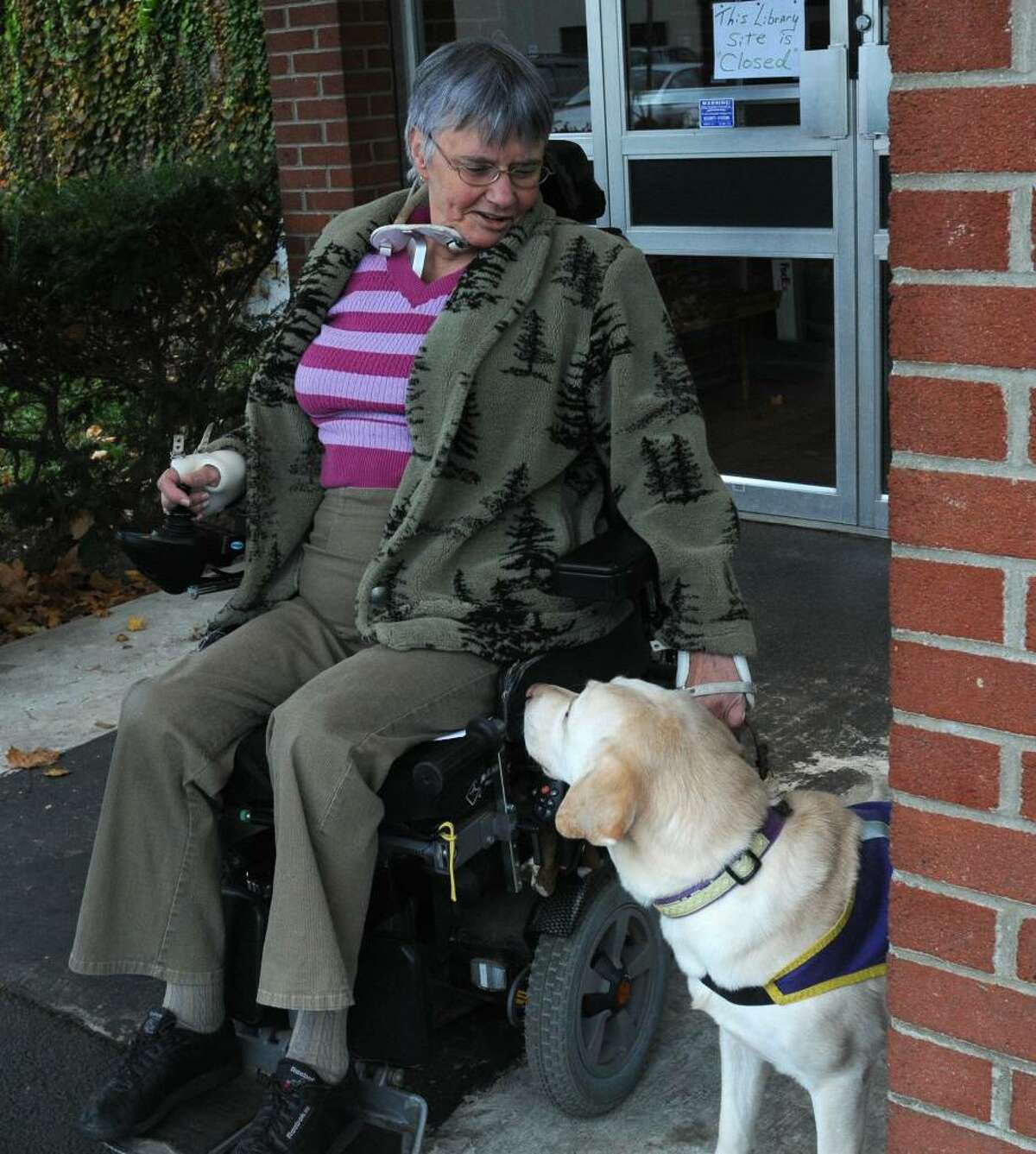 Fritz Smith of Colonie sits outside of the Elks Lodge on South Allen Street in Albany on Nov. 4, 2009. Fritz couldn't attend the meeting inside because the facility has no ramps for her wheelchair. She wanted to attend the meeting inside about the closing of the post offices in the Pine Hills and Delaware Ave. She lives in Colonie but the Pine Hills Post Office is wheelchair accessible. (Lori Van Buren / Times Union)