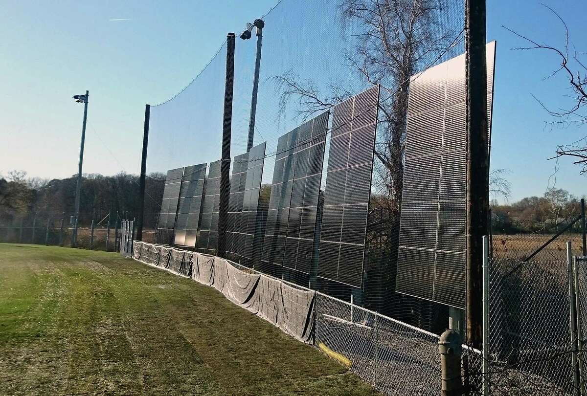 Solar panelsin the outfield at the Tom Haydon softball field on Old Dam Road are among the 32 solar energy projects the town has constructed. Fairfield,CT. 1/26/18