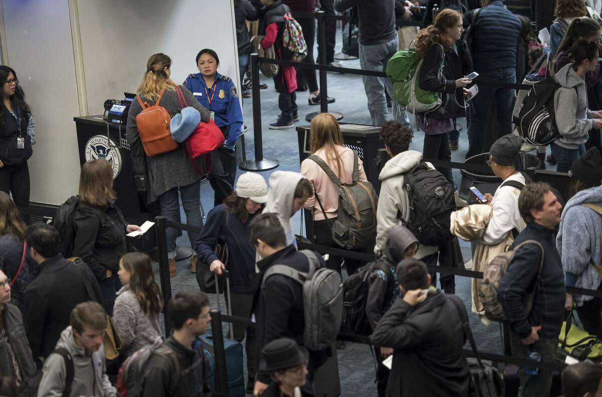 Travelers go through a security line at San Francisco International Airport (SFO) in San Francisco on Dec. 23, 2017.