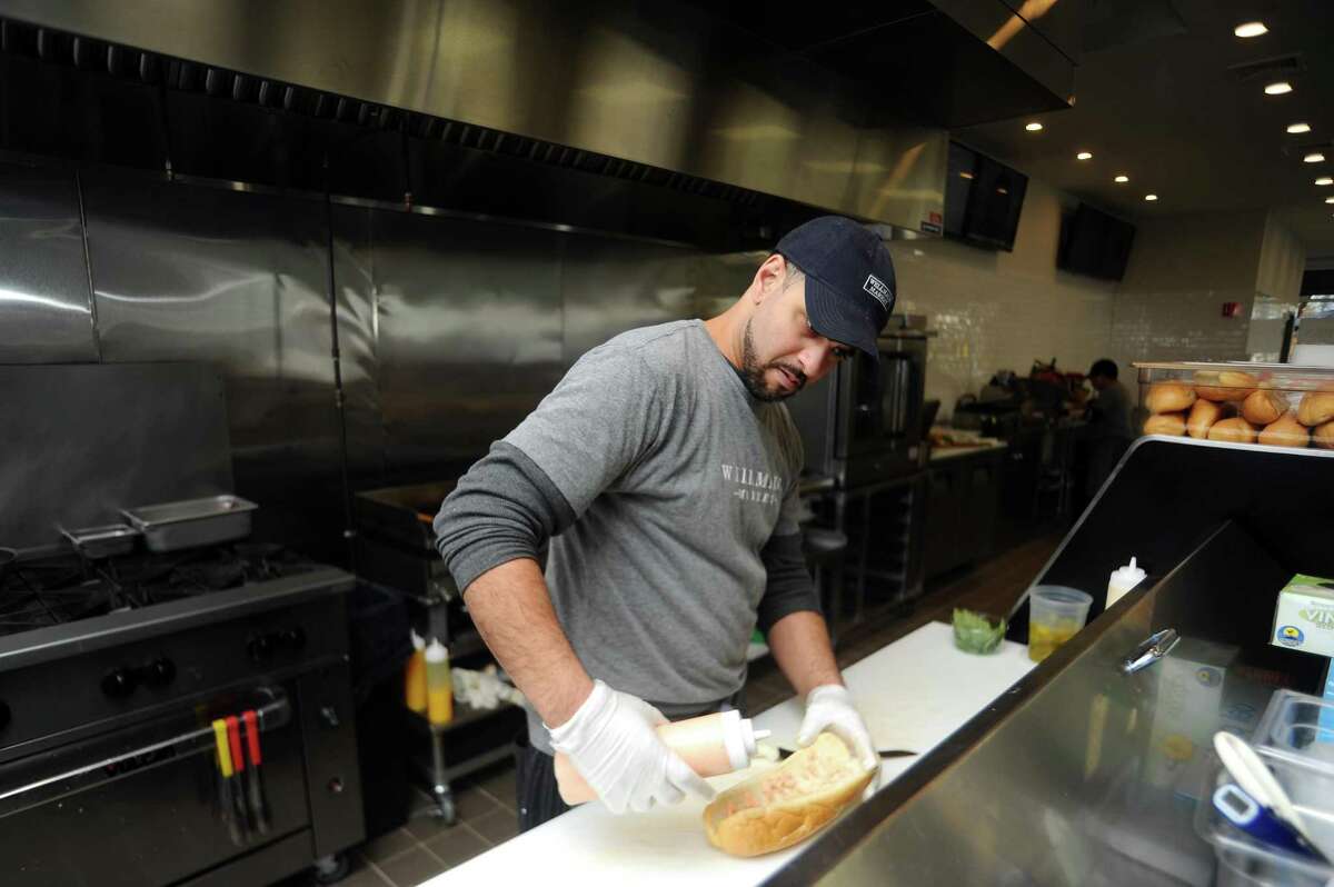 Sandwich chef Michael Stockwell makes a chicken burrata sandwich at the new Wellmade Market on East Putman Avenue in the Cos Cob section of Greenwich on Tuesday.