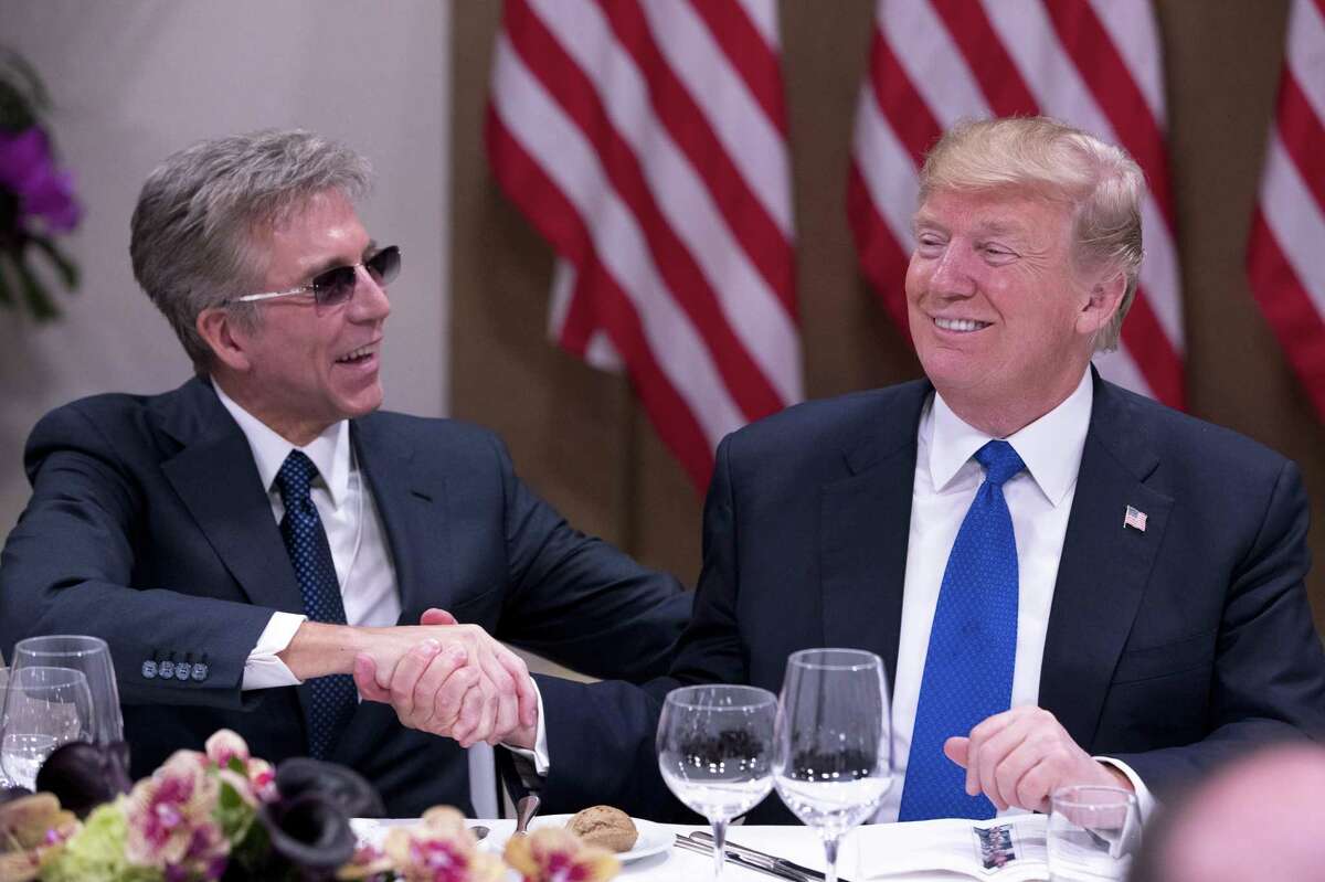 President Donald Trump shakes hands with Bill McDermott, the chief executive of SAP, at a dinner with business leaders at the World Economic Forum in Davos, Switzerland, Jan. 25, 2018.