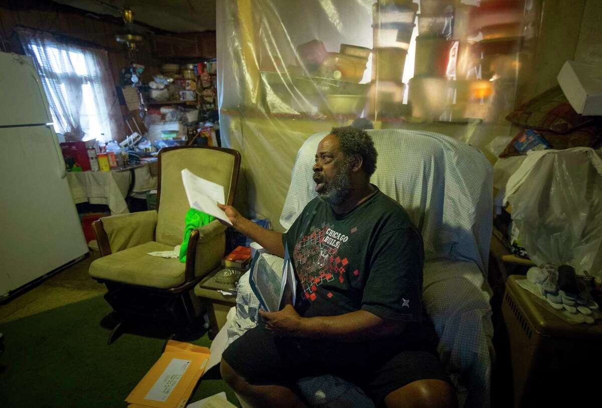 Herman Smallwood sorts through papers in his Aldine home, Thursday, Jan. 11, 2018. Smallwood was denied assistance from FEMA to repair his home after Hurricane Harvey. ( Mark Mulligan / Houston Chronicle )