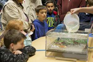 Children watch a demonstration of heavy rain and runoff 01/25/18 evening at the Petroleum Museum's Family Science Night, "Forces of Nature." Tim Fischer/Reporter-Telegram