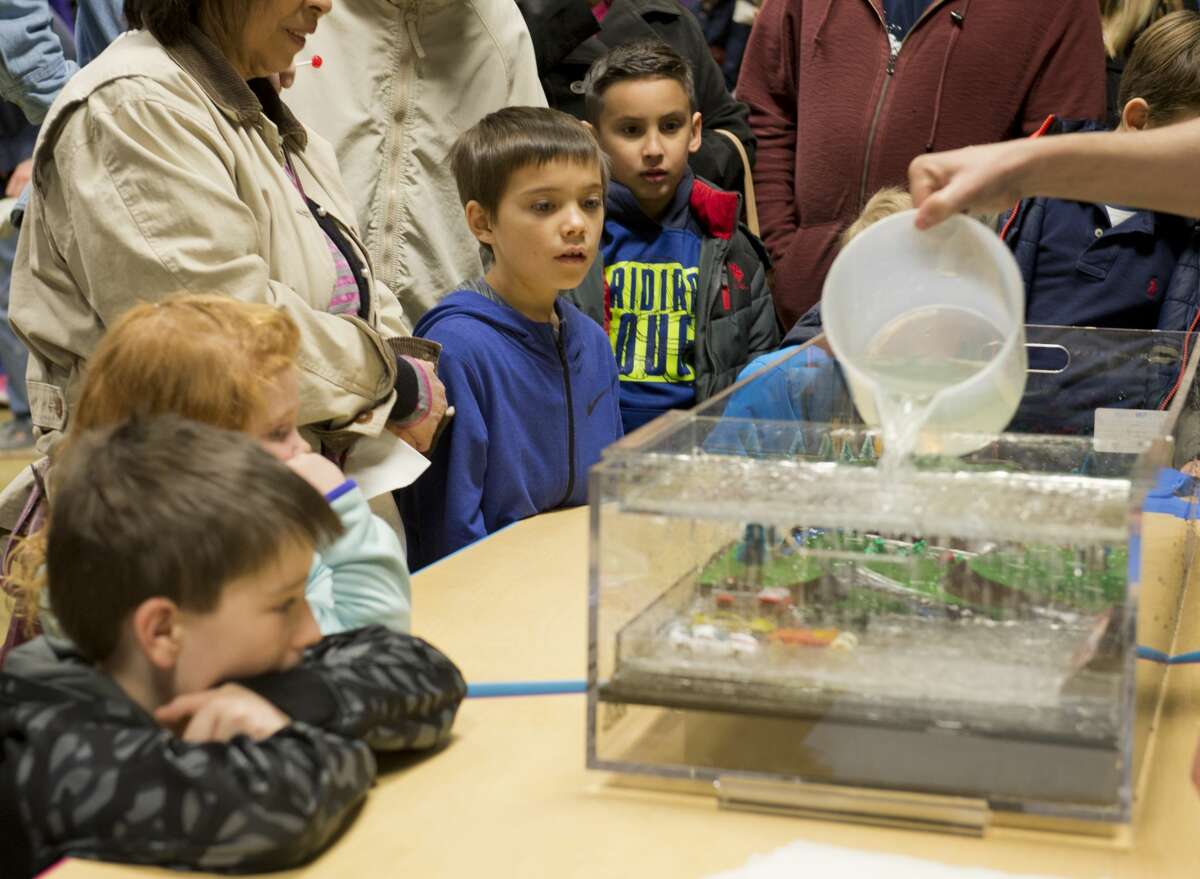 Children watch a demonstration of heavy rain and runoff in 2018 at the Petroleum Museum's Family Science Night, "Forces of Nature." Tim Fischer/Reporter-Telegram