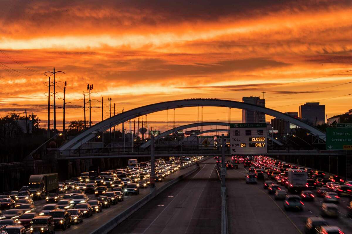 Commuters travel on U.S. 59, under bridges that were once lit up with colorful lights, as the sun sets on Thursday, Jan. 25, 2018, in Houston. The lights have been off the past several days because the Montrose Management District coiuldn't pay its bill.