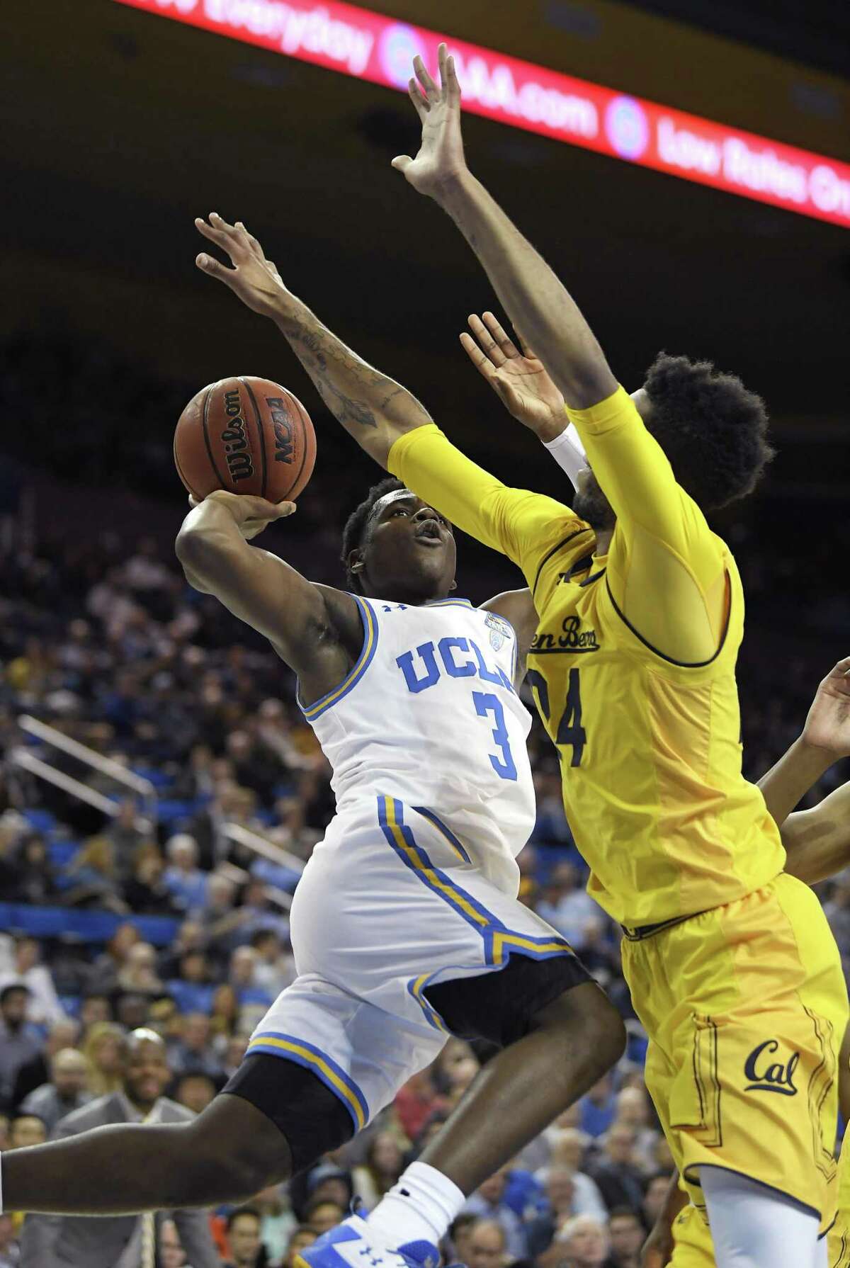 UCLA guard Aaron Holiday shoots as Cal forward Marcus Lee. The visiting Bears lost their seventh consecutive game.