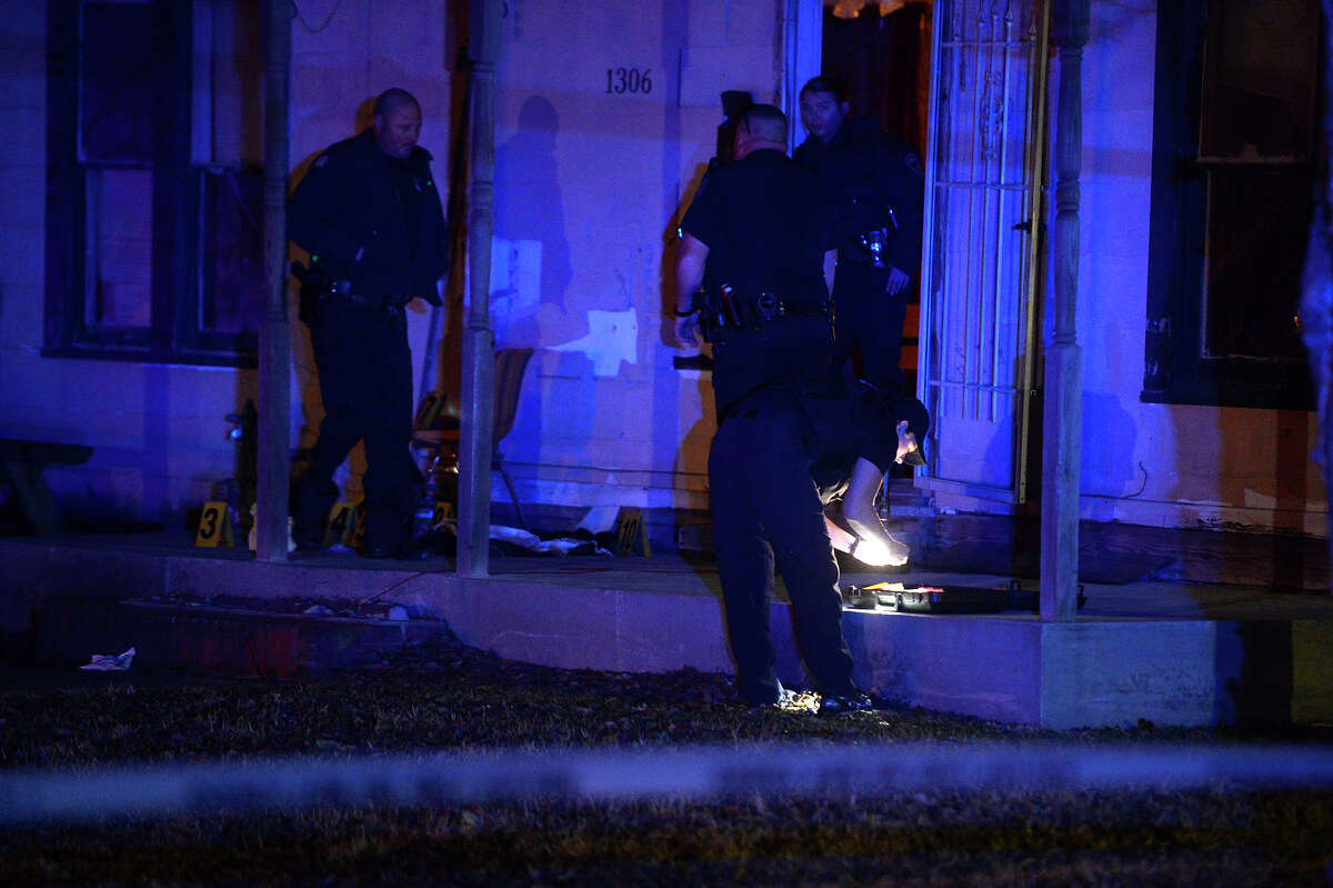 Port Arthur police investigate a shooting in the 1300 block of Trinity Ave. on Thursday night. A department spokesperson said two people were shot in the back of the head; one died at the scene. Photo taken Thursday 1/25/18 Ryan Pelham/The Enterprise