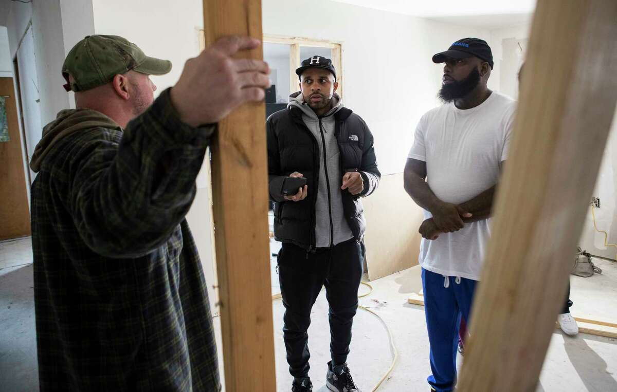 Justin "DJ Rogers" Rogers, left, and rapper Trae tha Truth, check out the progress of a home, damaged by Hurricane Harvey, they, along with Houston Rockets guard Gerald Green, are helping to rebuild on Friday, Jan. 19, 2018, in Houston. Green has spent months working with several families who were victims of Harvey's floods. ( Brett Coomer / Houston Chronicle )