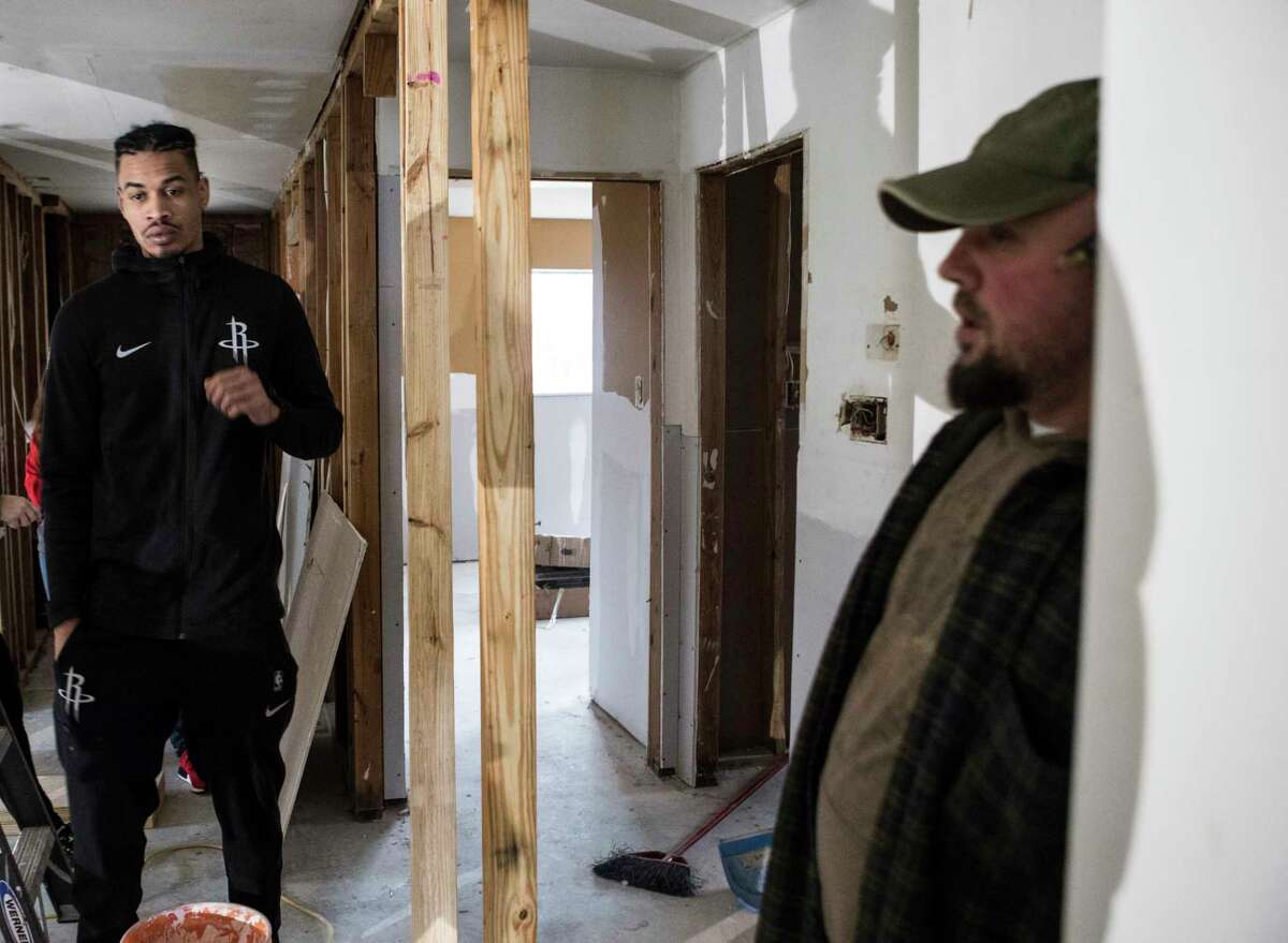THe Rockets' Gerald Green, left, examines a home damaged by Hurricane Harvey. Green, Trae tha Truth and Justin "DJ Mr. Rogers" Rogers are helping rebuild homes in Houston.﻿
