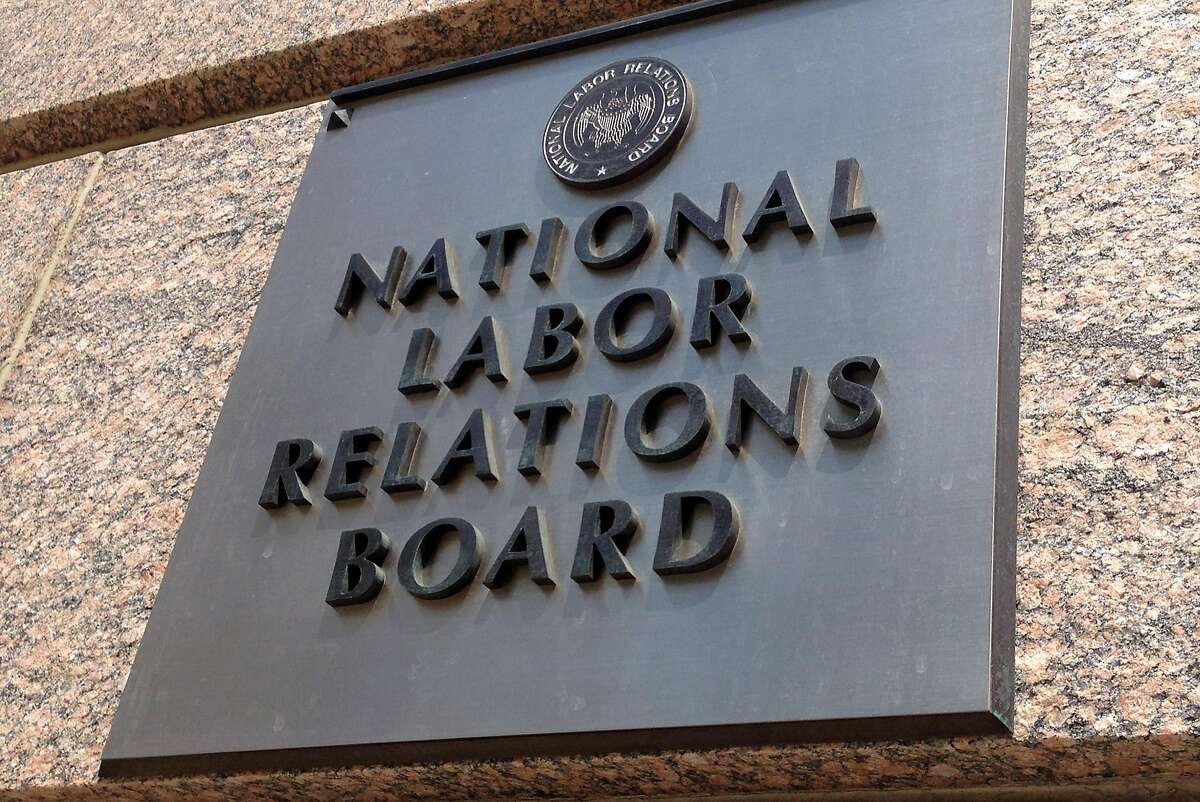 FILE - In this July 17, 2013 file photo, the sign for the National Labor Relations Board is seen on the building that houses their headquarters in Washington. The National Labor Relations Board issued a final rule on Friday aimed at modernizing and streamlining the union election process. The new rule will shorten the time between when an election is ordered and the election itself, eliminating a previous 25-day waiting period. And it seeks to reduce litigation that can be used to stall elections. It will also require employers to furnish union organizers with email addresses and phone numbers of workers. (AP Photo/Jon Elswick, File)