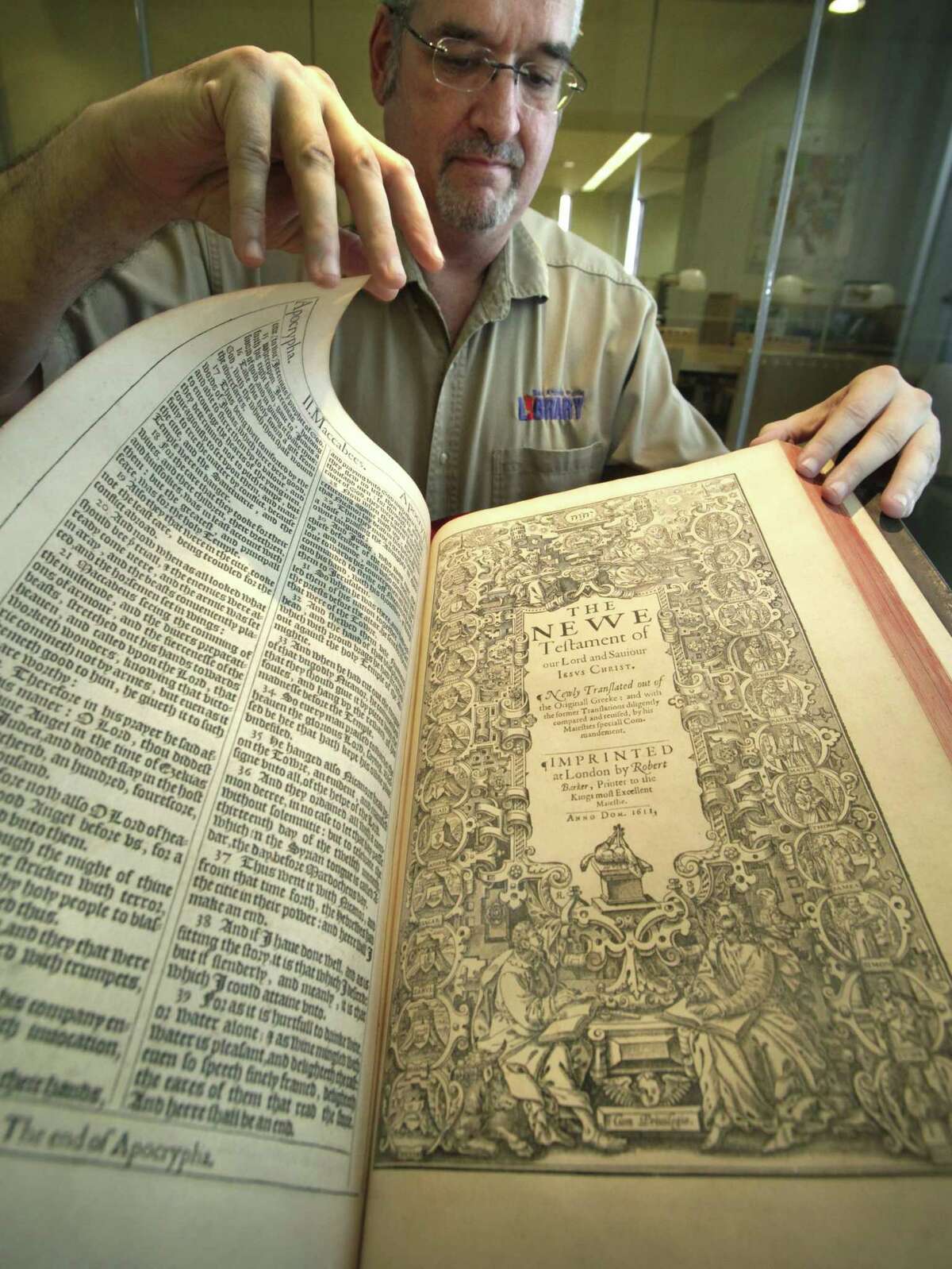 Matt DeWaelsche, assistant manager and archivist at San Antonio’s Central Library, turns the page on the first-edition 1611 King James Bible, which was part of the library's collection in 2011, when it turned 400 years old.