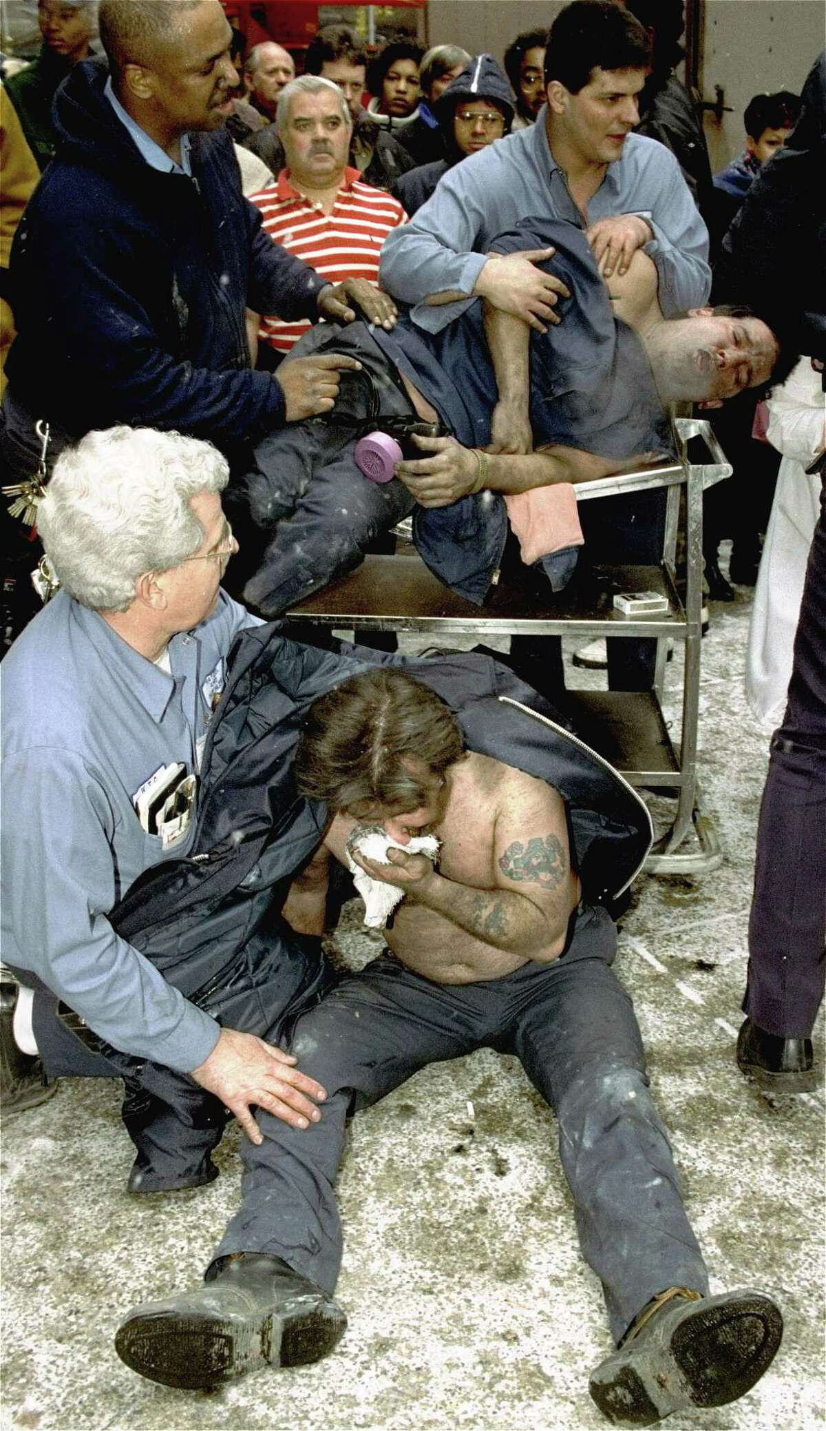 FILE - In this file photo of Feb. 26, 1993, victims of a fire at the World Trade Center in New York are treated at the scene after an explosion rocked the complex. The National September 11 Memorial & Museum on Friday, Jan. 26, 2018, announced the opening of a special installation to commemorate the 25th anniversary of the 1993 truck bombing of the World Trade Center. (AP Photo/Marty Lederhandler, File)