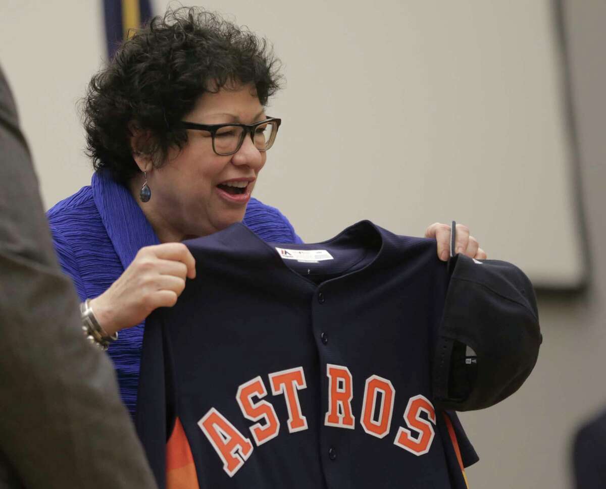 U.S. Supreme Court Justice Sonia Sotomayor holds up an Astros jersey﻿, the gift she was given along with an Astros cap when she spoke at the University of Houston Law Center on Friday﻿.