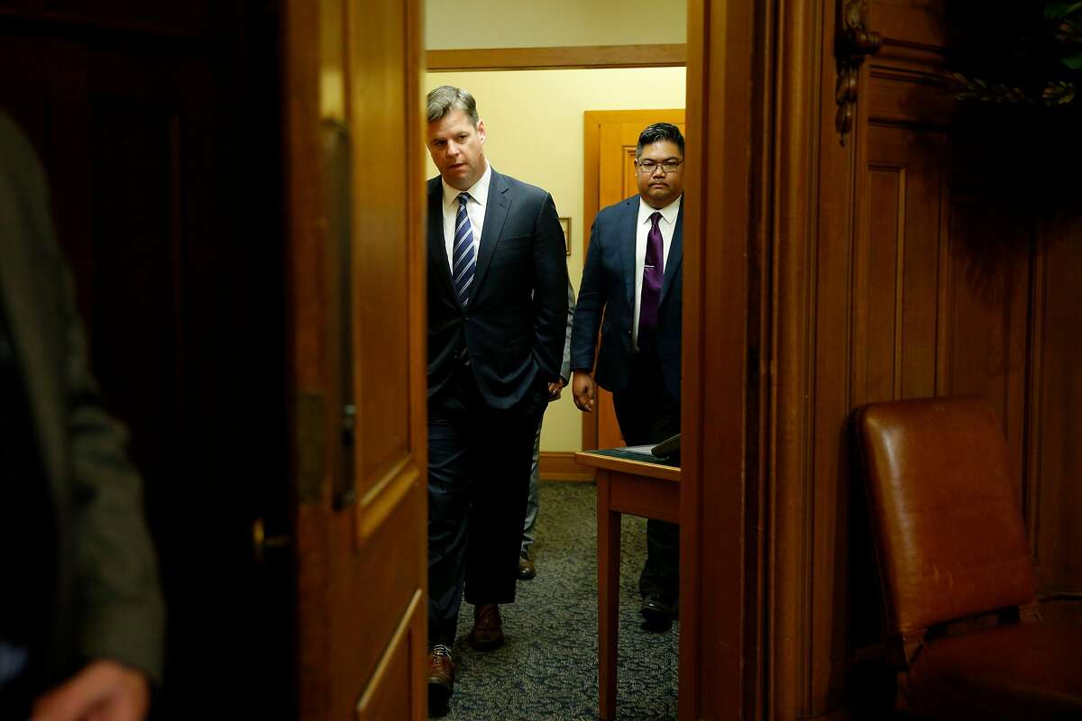 Supervisor Mark Farrell walks back into the meeting at City Hall after being voted interim mayor by the board of supervisors, Tuesday, Jan. 23, 2018, in San Francisco, Calif.