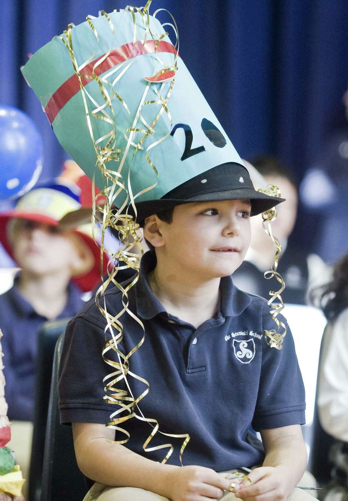 First-grader Ryan Robertson listens to the assembly speakers at the Stanwich School in Greenwich, celebrating its 20th birthday, or Charter Day, the anniversary of the school receiving its charter from the state of Connecticut. Friday, Jan. 26, 2018