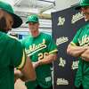 From left) Oakland A's infielders Marcus Semien, Matt Chapman, and Matt  Olson sport the 50th Anniversary edition jersey during a fashion show at  the Oakland A's Headquarters Friday, Jan. 26, 2018 in