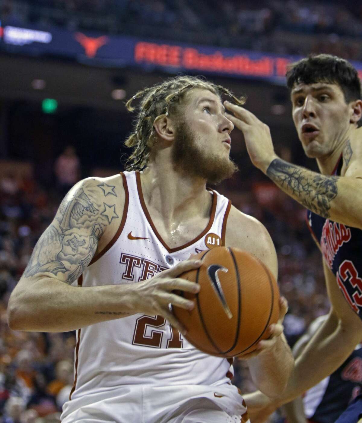 Texas forward Dylan Osetkowski, left, looks to shoot against Mississippi center Justas Furmanavicius, right, during the second half of an NCAA college basketball game, Saturday, Jan. 27, 2018, in Austin, Texas. Texas won 85-72. (AP Photo/Michael Thomas)
