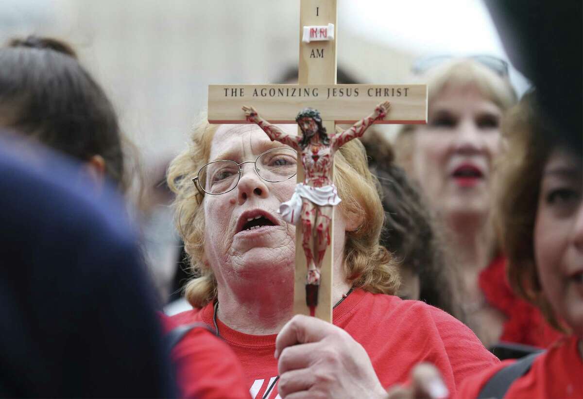 Elizabeth Jimenez of Georgetown carries a wooden cross of Christ as she attends The Texas Rally for Life which brought a large crowd to march and gather at the Texas Capitol where they heard Texas Gov. Greg Abbott support pro-life and laws that benefit pro-life in Austin on Saturday, Jan. 27, 2018. (Kin Man Hui/San Antonio Express-News)