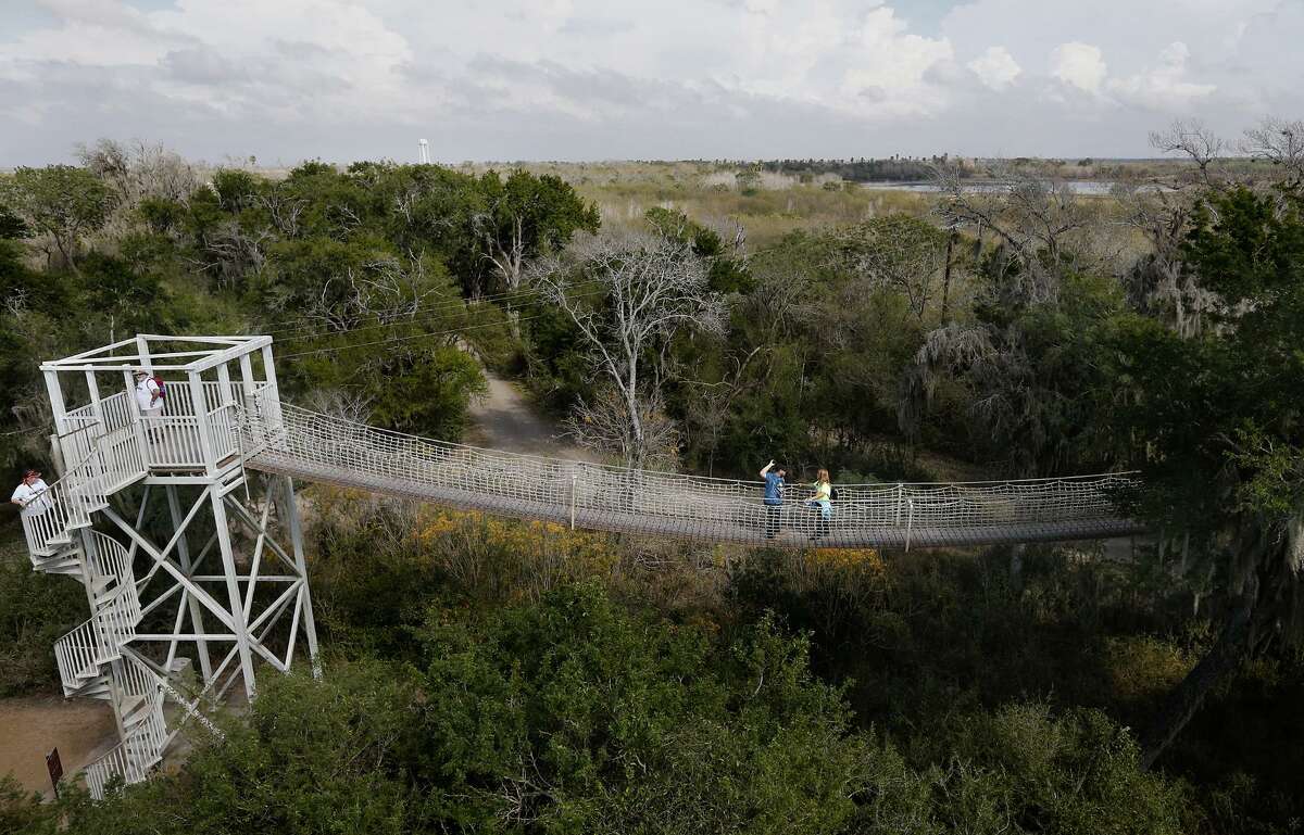 People take in the sights from the canopy bridge at the Santa Ana National Wildlife Refuge Saturday Jan. 27, 2018 in Alamo, Tx.