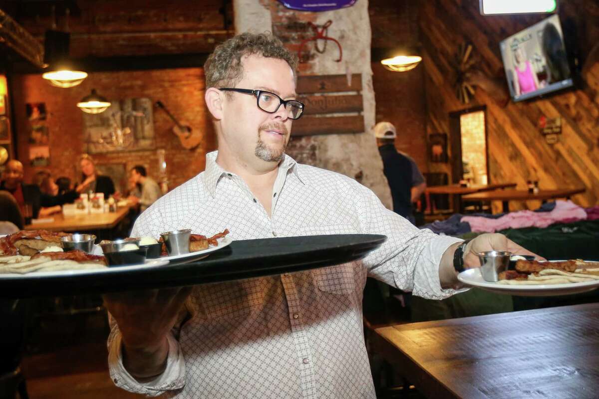 Teak Daniele, Operations Director at Pacific Yard House, serves pancakes during a pancake breakfast and book signing fundraiser for PTSD awareness with the Conroe Professional Firefighters Association on Saturday, Jan. 27, 2018, at Pacific Yard House in Conroe.